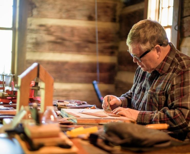 A man meticulously demonstrates his traditional trade at the Round Top Folk Festival.