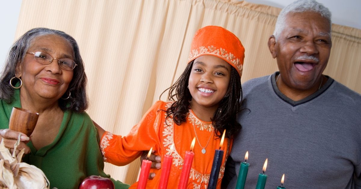 girl and her family celebrating kwanzaa