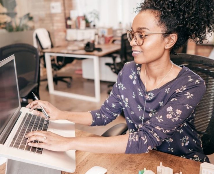 woman sititng at a computer working on taxes