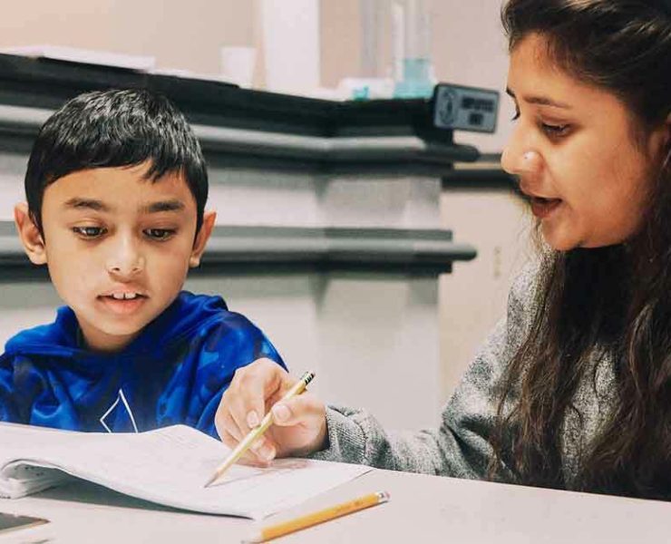 student and his tutor studying at Rocket City Learning Center