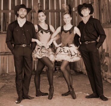 Four ballet performers from Huntsville Ballet's Tumbleweed Suite stand together in costume.