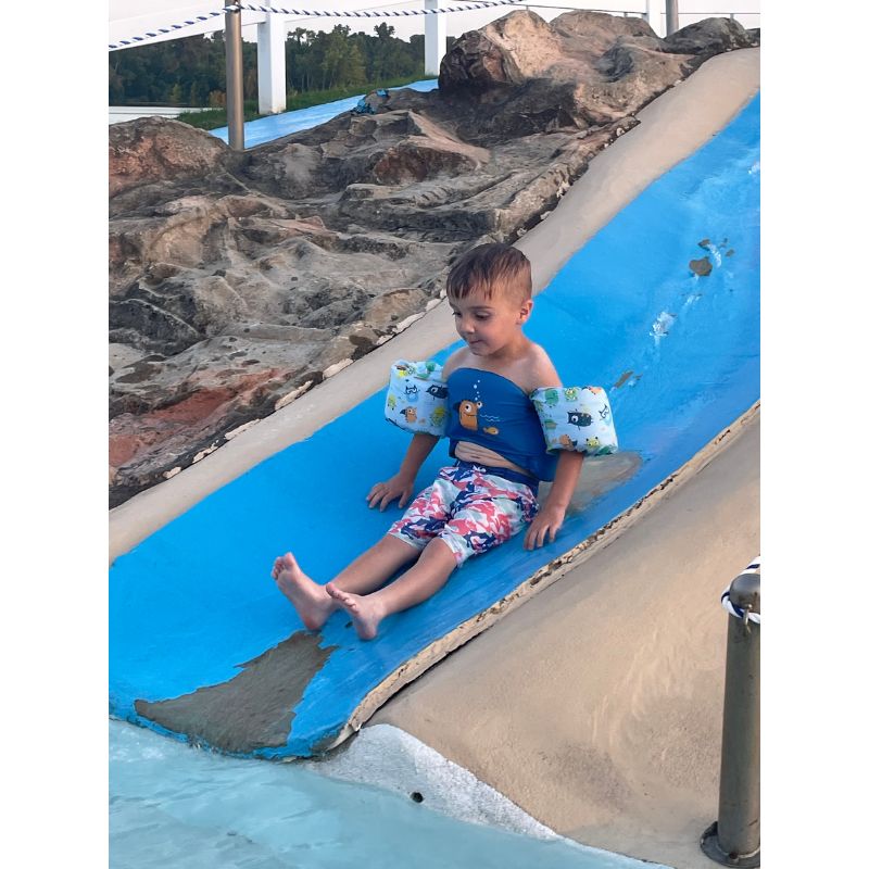 Sweet boy smiling while sliding in the Duck Pond at Point Mallard