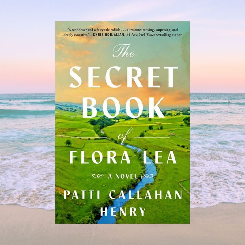 The cover of The Secret Book of Flora Lea can be seen on the backdrop of a beach. 
