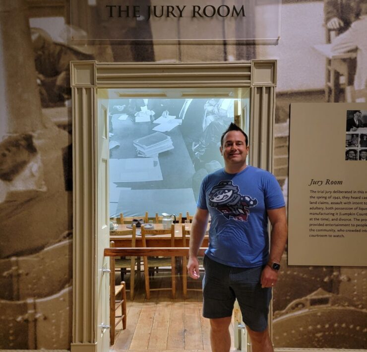 A man poses outside the jury room of the oldest courtroom in Georgia.