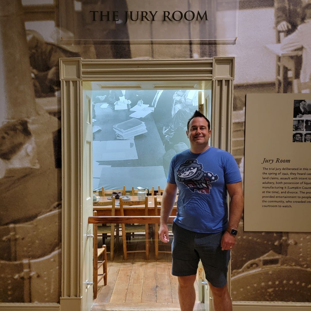A man poses outside the jury room of the oldest courtroom in Georgia.